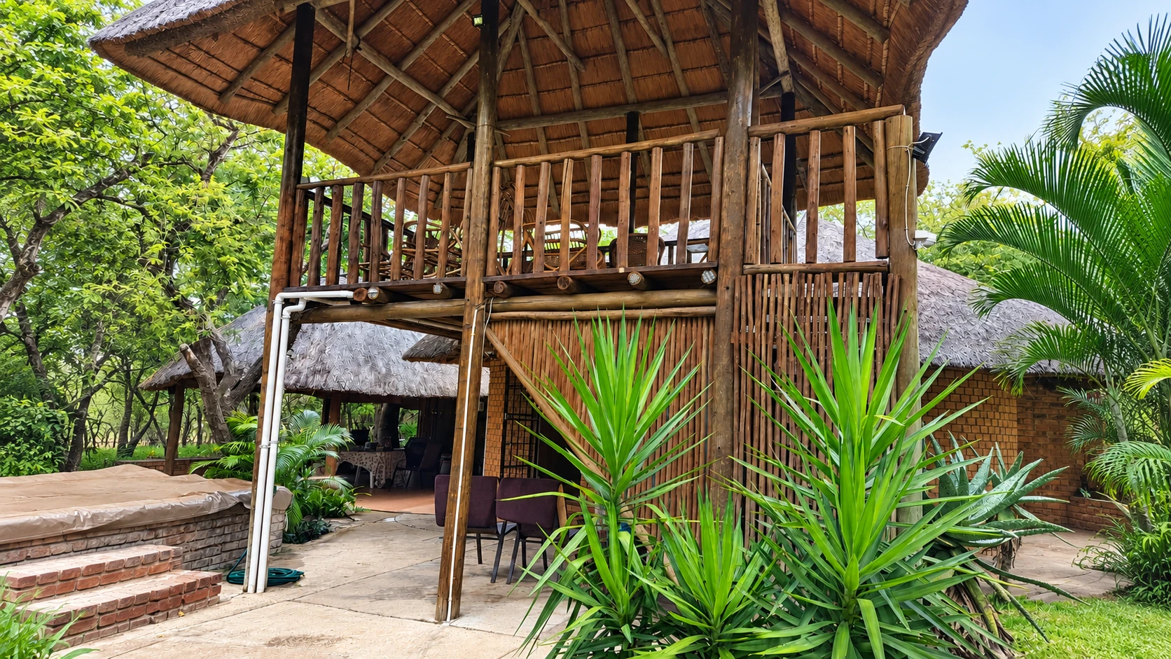 Bush Lodge thatched exterior and garden